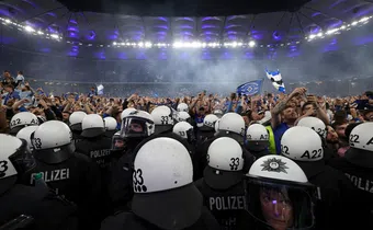 Wild stadium invasion and police clash leaves 25 fans seriously injured