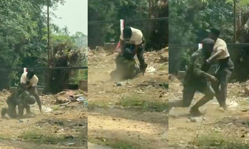 Soldier struggles for freedom as civilian pins him to the ground during scuffle (video)