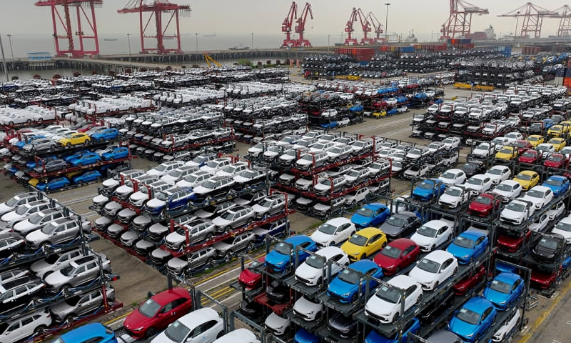 This aerial photograph taken on April 16, 2024 shows electric cars for export stacked at the international container terminal of Taicang Port in Suzhou, in China's eastern Jiangsu Province. (Photo by AFP)