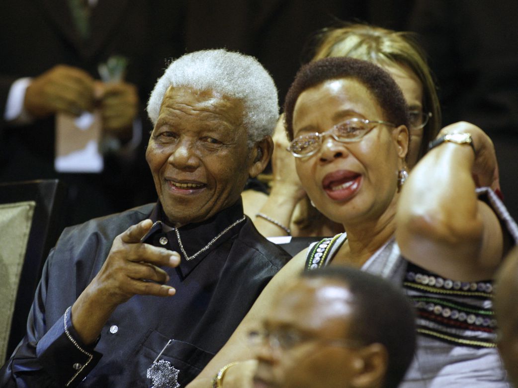 Ex-South African president Nelson Mandela's, (L) points beside his wife Graca Machel (R) from the parliament gallery in Cape Town on February 11, 2010 during a celebration for the 20th year of the icon's freedom from apartheid prison. [Getty Images]