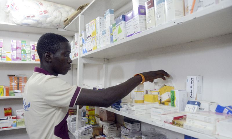 A pharmacist searches for drugs in a pharmacy in Lagos on July 26, 2014. [Getty Images]