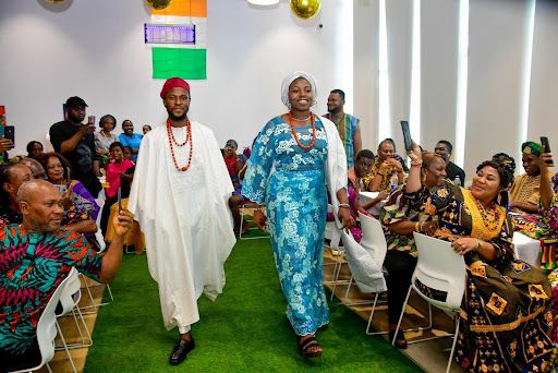 Staff engaging in a fashion show to showcase African attire