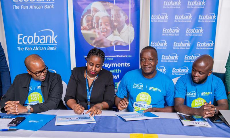Ecobank Uganda Head of Commercial Banking, Elizabeth Mwerinde Kassedde and Moses Okiror, CEO SurePay signing the MEO at the launch of the partnership.