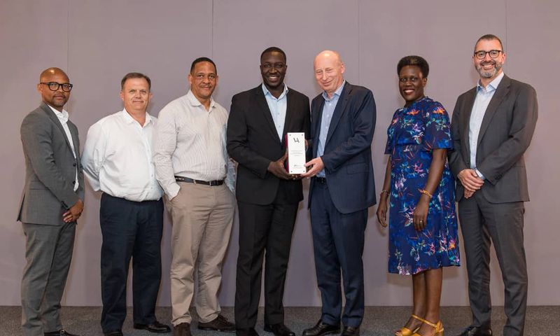 Vivo Energy Group CEO Stan Mittelman (3R), presents the Vivo Award to the Uganda Team led by the MD, Joanita Mukasa Menya (2R) and the officials at the conference recently.