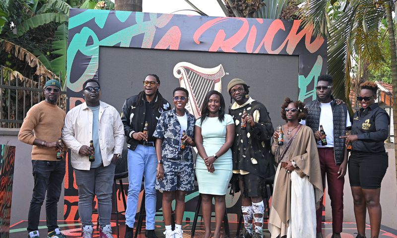 The influencers pose for a photo with Elizabeth Mutamuliza, Head of Beer at Uganda Breweries Limited (middle)