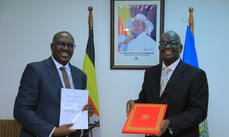 UBL Managing Director Andrew Kilonzo with Mr Bagiire Vincent Waiswa, Permanent Secretary for the Ministry of Foreign Affairs, at the deal signing