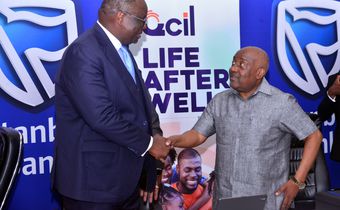 Stanbic Bank Chief Executive Mumba Kalifungwa interacts with Quality Chemicals Managing Director Mr. Katongole Emmanuel during the partnership signing event in Kampala