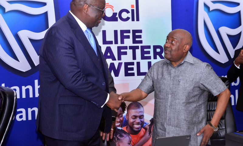 Stanbic Bank Chief Executive Mumba Kalifungwa interacts with Quality Chemicals Managing Director Mr. Katongole Emmanuel during the partnership signing event in Kampala