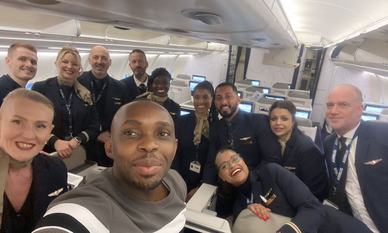 Dr. Jonathan Ssozi  Mulungi posing with the flight crew on a Brussels Airlines flight