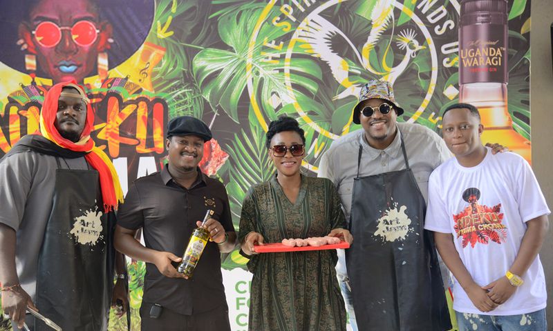 (2nd Left) Uganda Waragi Brand Manager Hillary Baguma and MC Uganda (1st right) Ndeku Nyama Choma organizer at the the launcg of the 4th edition of the festival at Shisa Nyama Village