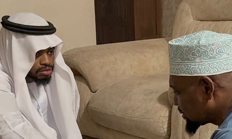 Diamond Platnumz shakes hands with a representative of the Othman family after dowry payment was accepted