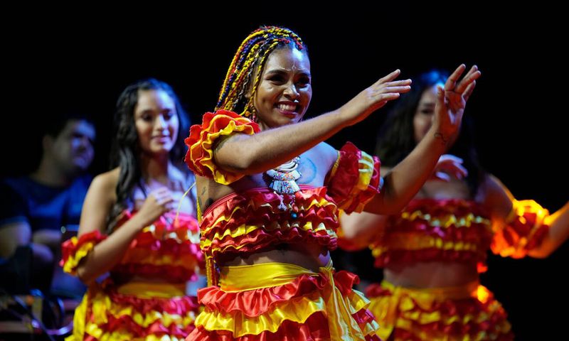 Members of the Paraguay-African cultural group Kamba Cua dance during celebrations in honor of Saint Balthazar, one of the Three Kings, on Epiphany in Fernando de la Mora, Paraguay, just after midnight Sunday, Jan. 9, 2022.