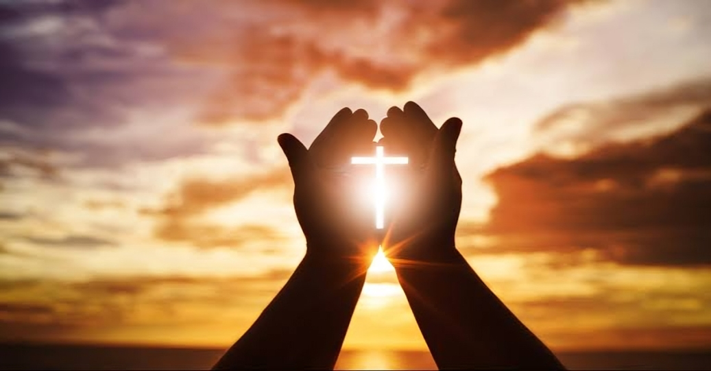 Someone raising their hands in prayer