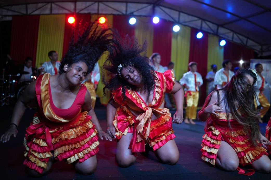 Members of the Paraguay-African cultural group Kamba Cua dance during celebrations in honor of Saint Balthazar, one of the Three Kings, on Epiphany in Fernando de la Mora, Paraguay, just after midnight Sunday, January 9, 2022.
