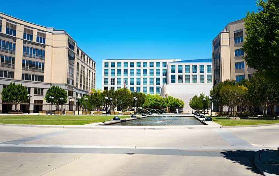 Fountains in the courtyard of the University Circle office complex, with top of the Four Seasons Hotel Silicon Valley visible, East Palo Alto, California