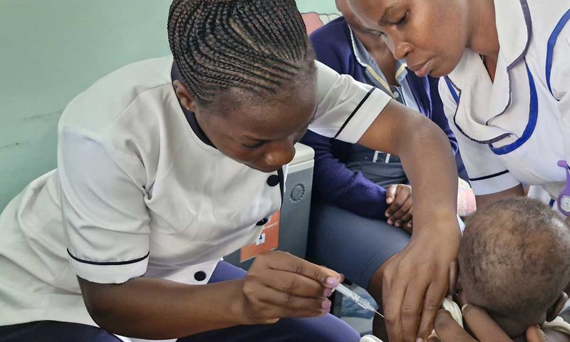 Nurses administering a vaccine