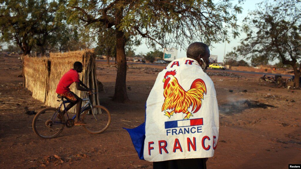 A man wears a French flag to show support for the French military intervention in Mali, in the capital, Bamako, Jan. 14, 2013.
