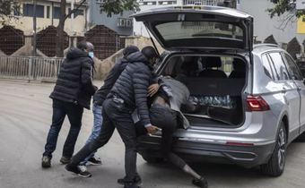 Plainclothes officers arrest a man in Nairobi, Kenya