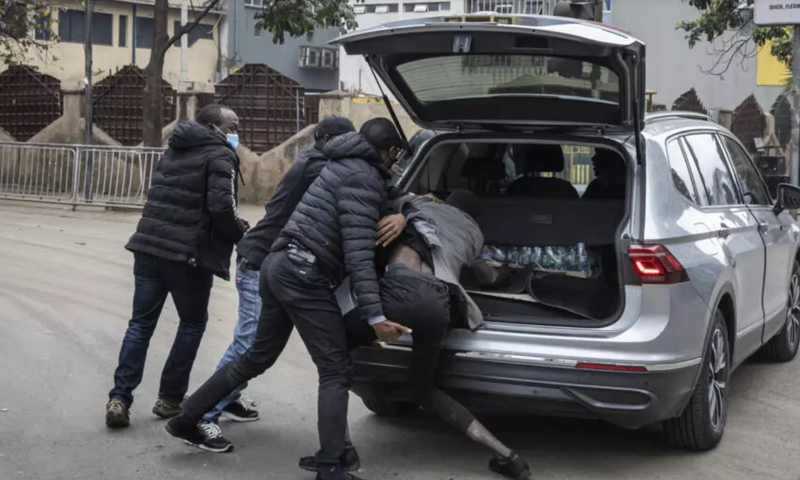 Plainclothes officers arrest a man in Nairobi, Kenya