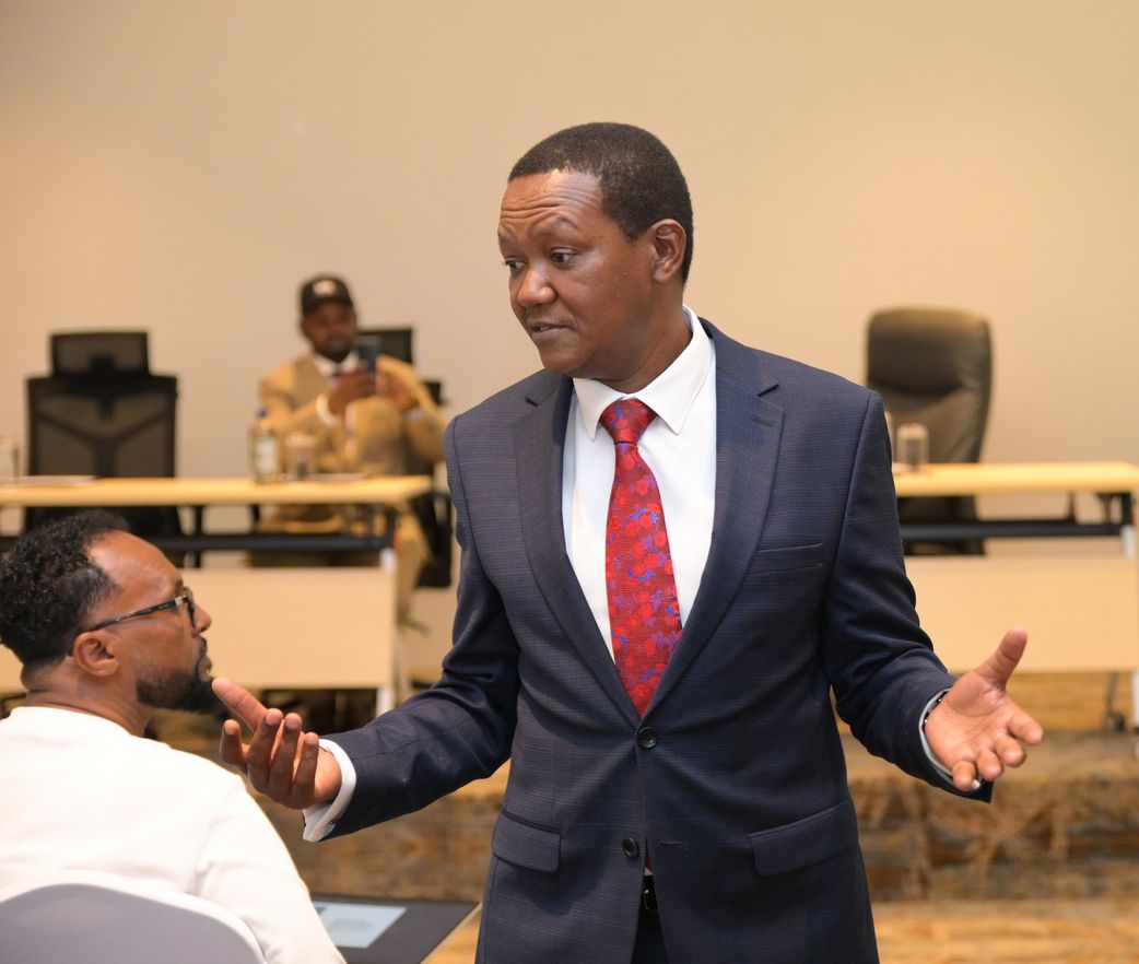 Labour and Social Protection Cabinet Secretary Alfred Mutua seeing off Kenyans who recently got jobs abroad
