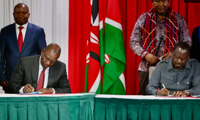 President William Ruto and Raila Odinga signing a political pact at KICC on March 7, 2025 with DP Kithure Kindiki and Senator Ledama Ole Kina standing in the background