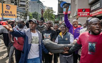 Good Samaritans rushing injured protestor to hospital. Photo/Courtesy