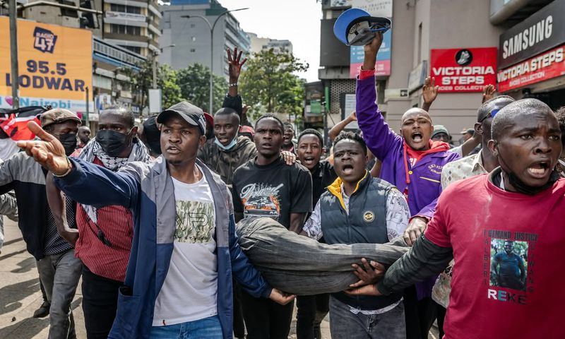Good Samaritans rushing injured protestor to hospital. Photo/Courtesy