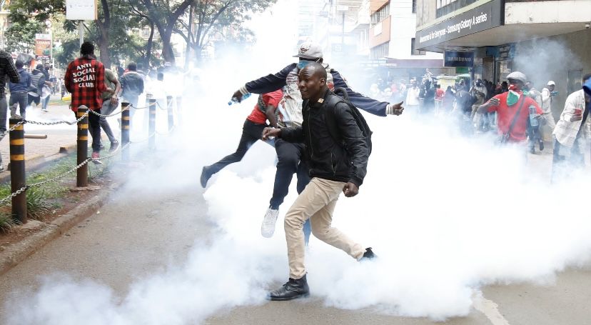 A protester running away from teargas