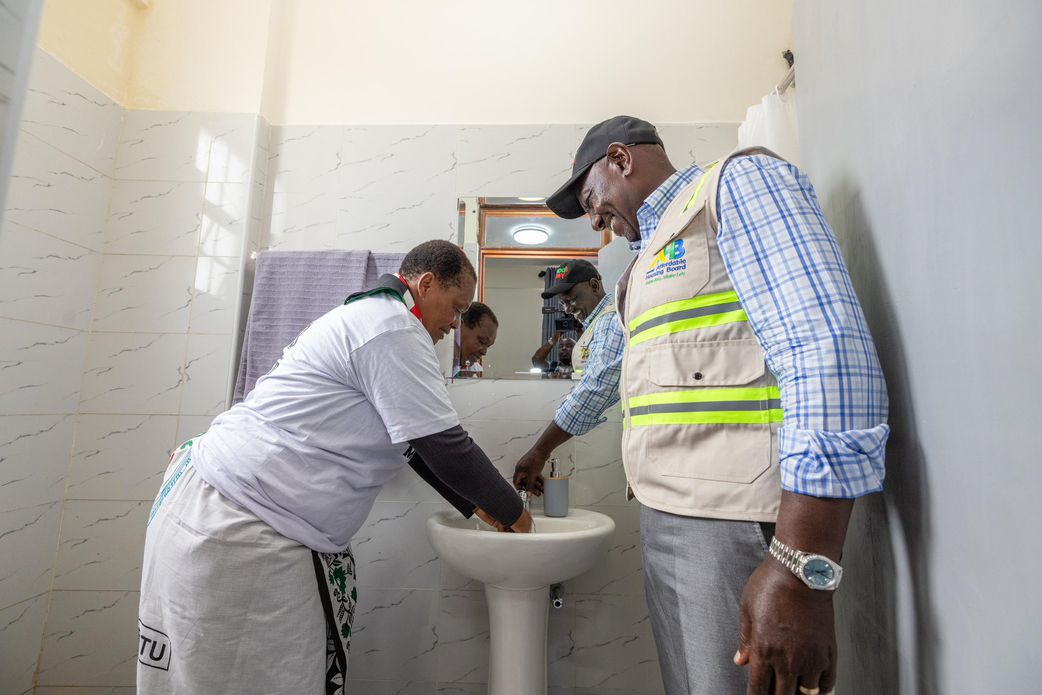 President William Ruto with a resident of the Mukuru Housing Units