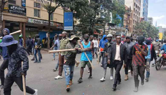 Armed goons pictured walking in the streets of Nairobi during protests earlier this week