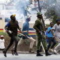 Armed goons pictured walking alongside the police in the streets of Nairobi during protests in Nairobi earlier this week