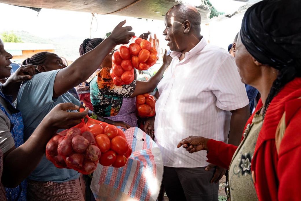 Former Interior CS Fred Matiang'i interacting with traders and purchasing local commodities in Kitui on December 20, 2024.