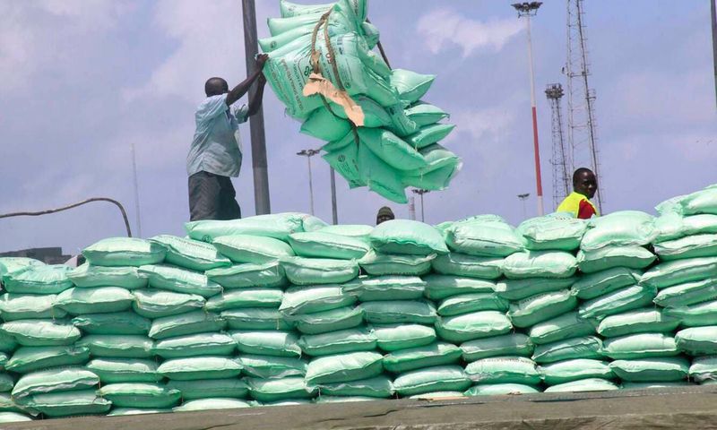 Dockworkers off-loading sugar at the port of Mombasa,