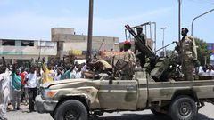 Sudanese greet army soldiers, loyal to army chief Abdel Fattah al-Burhan, in the Red Sea city of Port Sudan on April 16, 2023.AFP via Getty Images