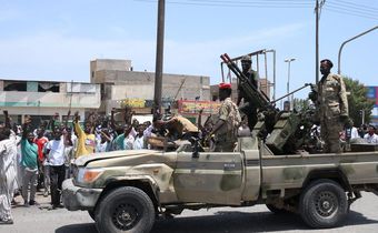 Sudanese greet army soldiers, loyal to army chief Abdel Fattah al-Burhan, in the Red Sea city of Port Sudan on April 16, 2023.AFP via Getty Images