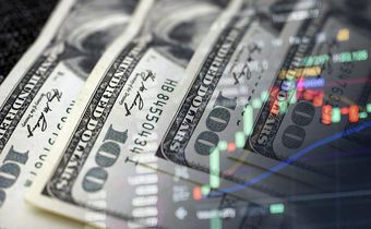 Cash dollars and stock market indicators (inflation, economy, crisis, finance)Getty Images