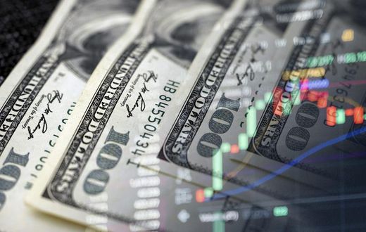 Cash dollars and stock market indicators (inflation, economy, crisis, finance)Getty Images