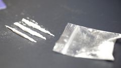 A stock photo shows a bag of cocaine with lines of the drug.Getty Images