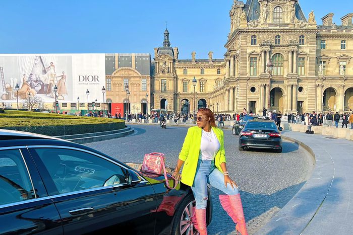 Emma Lohoues à Paris devant une voiture de luxe