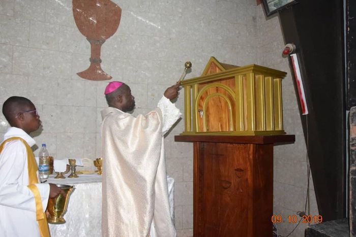 à l'Église Catholique saint Jean l’évangéliste de Yopougon, un prêtre prépare la communion