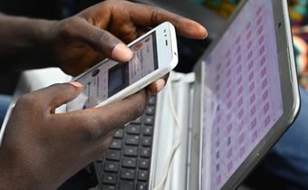 Un jeune manipulant son téléphone/Le Monde
