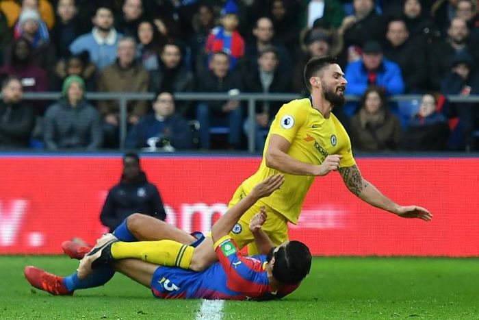 Olivier Giroud (top), pictured colliding with Crystal Palace's James Tomkins, joined a growing Chelsea injury-list during a 1-0 win at Selhurst Park in a Premier League match on Sunday
