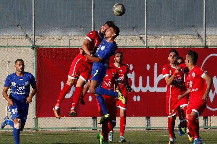 Players from Shabab Rafah (in blue) and Ahly al-Khalil tussle for the ball during the second leg of the Palestinian Cup final on August 4, 2017
