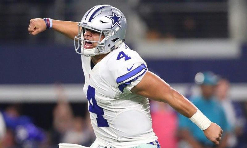 Dak Prescott of the Dallas Cowboys celebrates after throwing a touchdown pass during the fourth quarter against the Green Bay Packers in the NFC Divisional Playoff game at AT&T Stadium on January 15, 2017 in Arlington, Texas