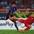 Vietnam defender Nguyen Trong Hoang (R) and Philippines forward Patrick Reichelt fight for the ball during the second leg of their AFF Suzuki Cup semifinal in Hanoi