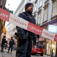 Austrian policemen stand guard at the site of a shooting outside Figlmueller passage in the city center of Vienna on December 21, 2018