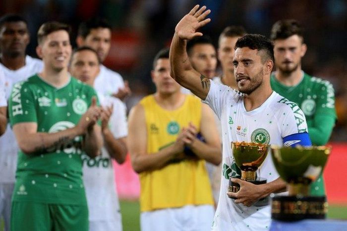 Chapecoense's defender Alan Ruschel waves as he holds the second place trophy at the Camp Nou stadium in Barcelona on August 7, 2017