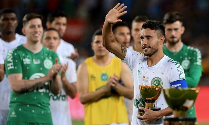 Chapecoense's defender Alan Ruschel waves as he holds the second place trophy at the Camp Nou stadium in Barcelona on August 7, 2017
