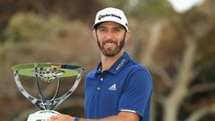 Dustin Johnson of the US poses with the trophy after putting for birdie on the 18th green to defeat compatriot Jordan Spieth in a playoff to win The Northern Trust, at Glen Oaks Club in Westbury, New York, on August 27, 2017