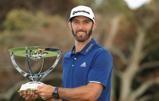 Dustin Johnson of the US poses with the trophy after putting for birdie on the 18th green to defeat compatriot Jordan Spieth in a playoff to win The Northern Trust, at Glen Oaks Club in Westbury, New York, on August 27, 2017